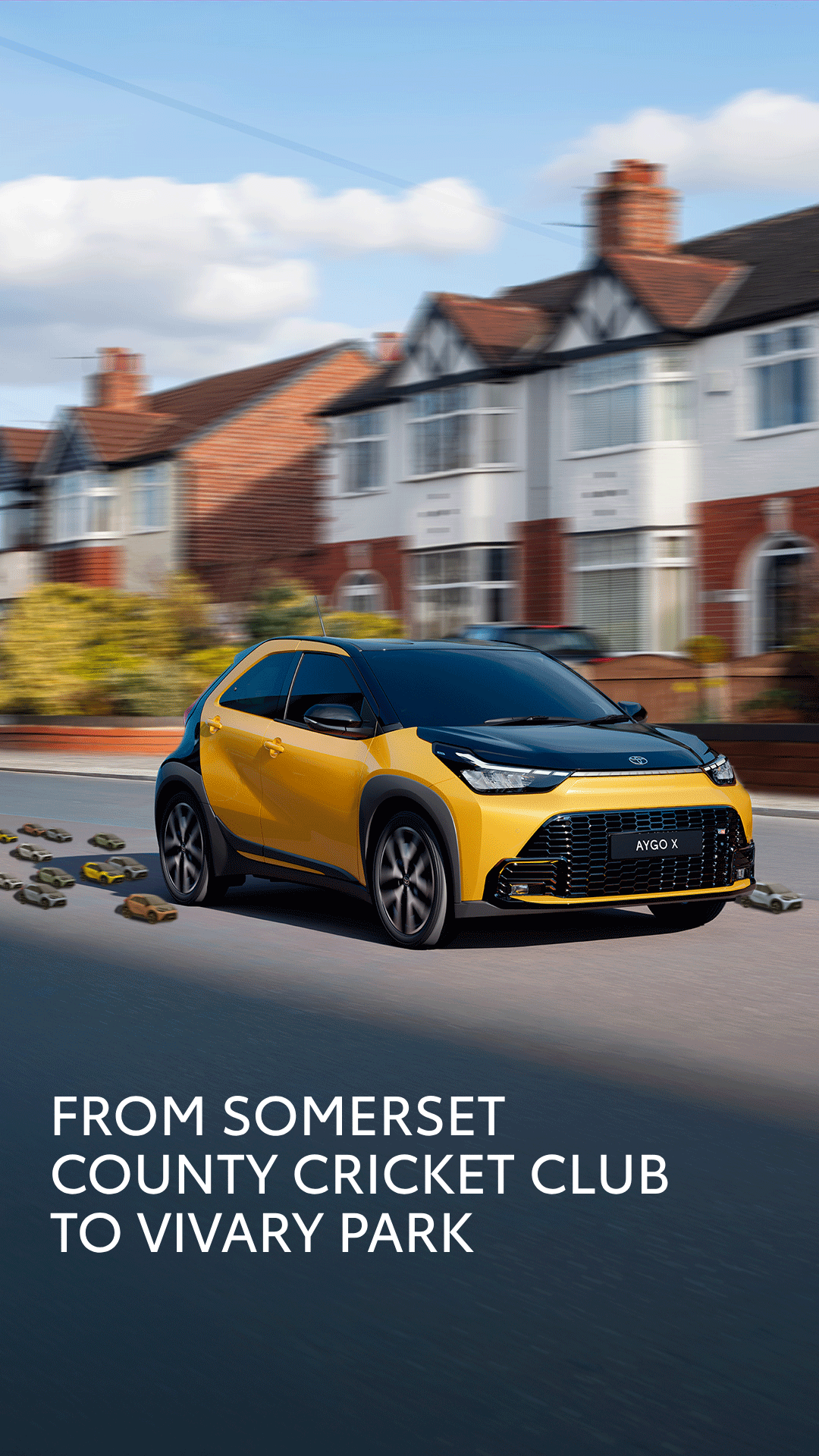 Yellow and black Toyota Aygo X speeding along a suburban street with brick houses, motion blur in the background; foreground text promotes Somerset cricket club to Vivary Park.